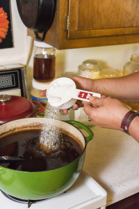 Sugar is added to the tea which feeds the scuby's and accelerates fermantation. Megan Lundahl making Kombucha at home in Sturgeon Bay. Photo by Len Villano.