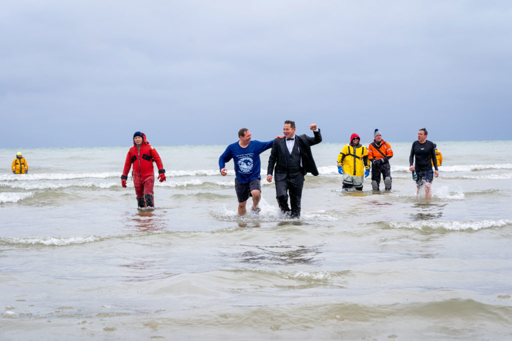 As is customary, original plunger J.R. Jarosh (right, in tux) and his brother Jon are the last to finish the swim.